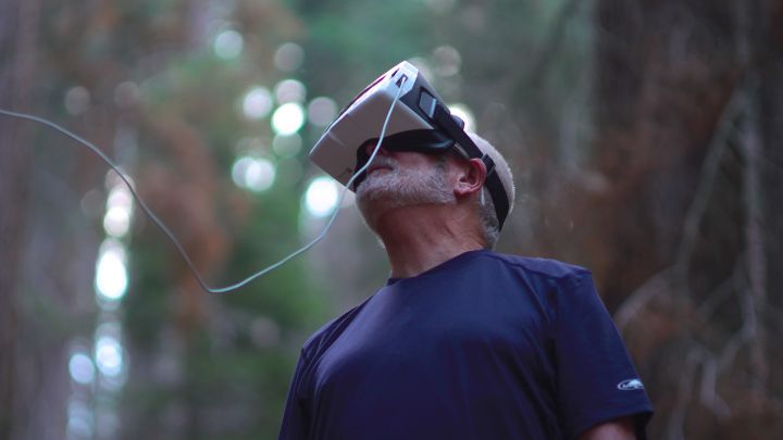 Researcher looking into a VR headset to see images captured by a drone